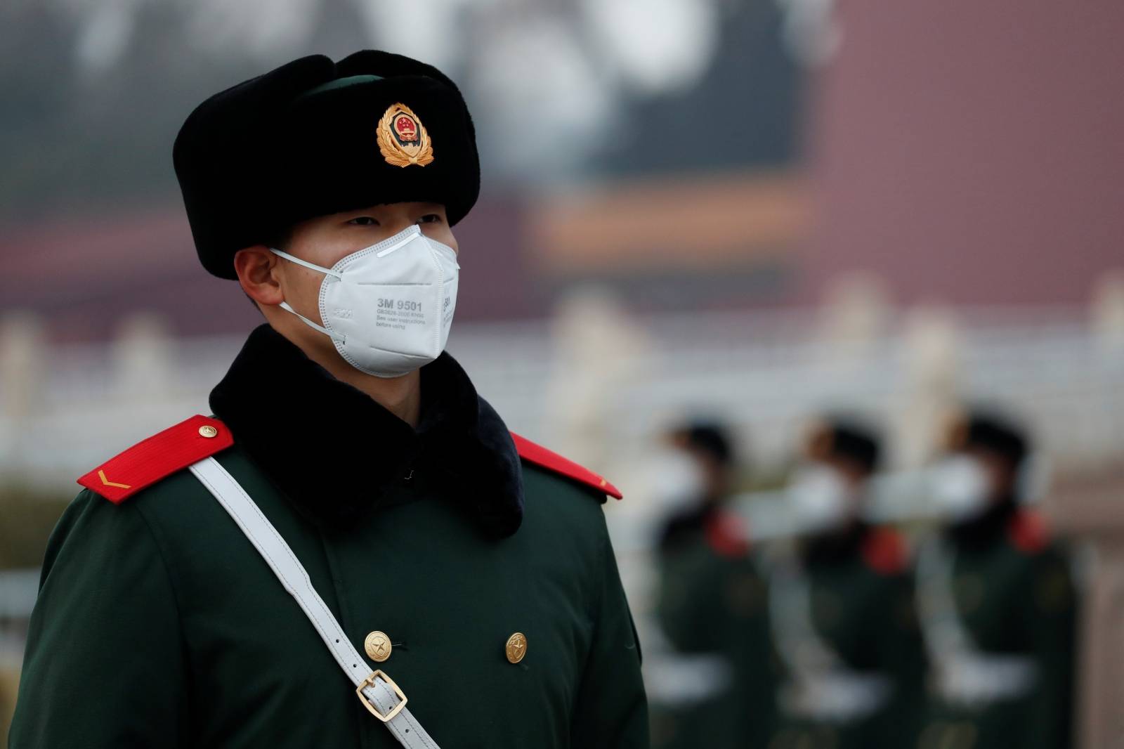 A paramilitary officer wearing a face masks stands guard at the Tiananmen Gate, as the country is hit by an outbreak of the new coronavirus, in Beijing