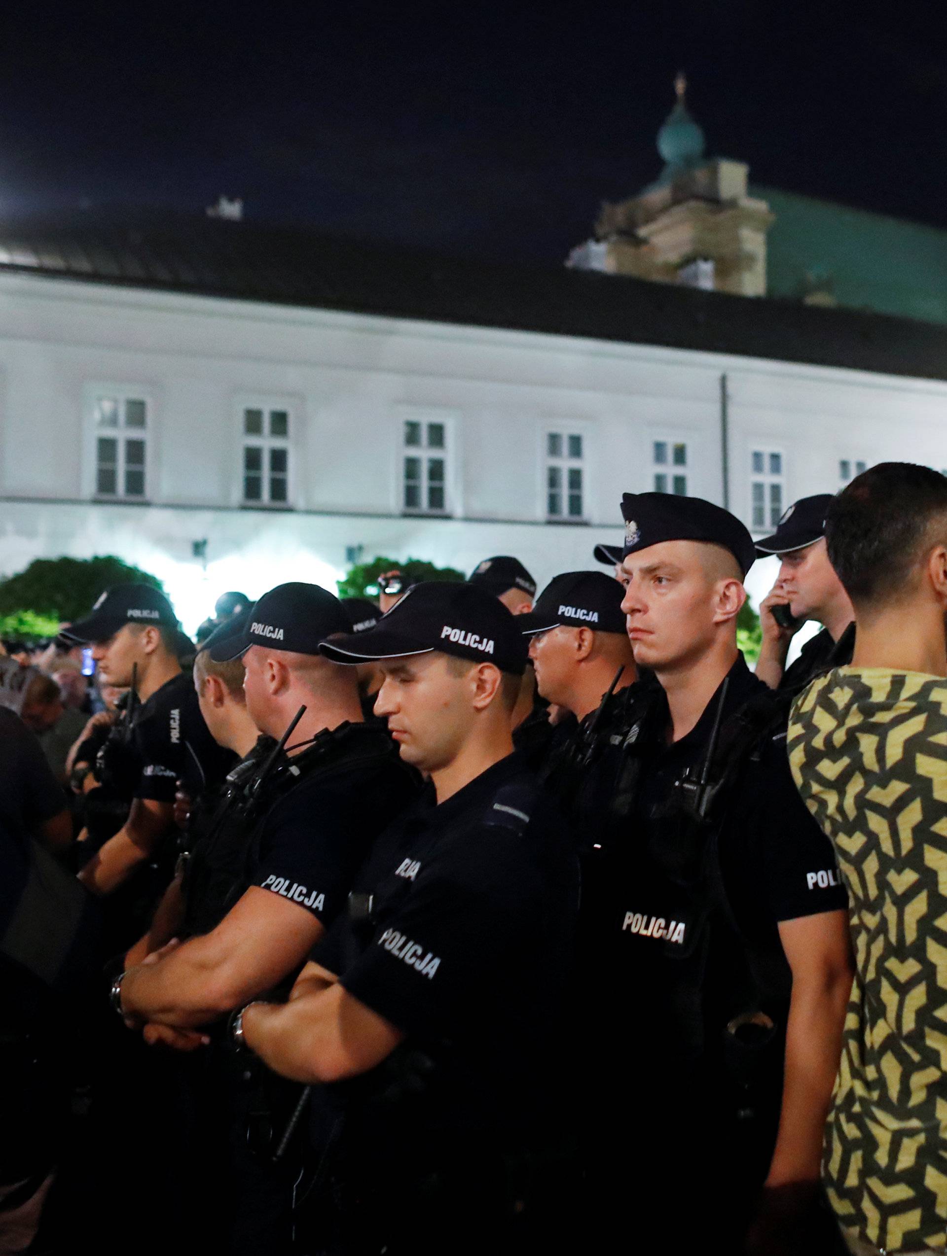 Police officers stand guard during the "Chain of lights" protest against judicial overhaul in front of the Presidential Palace in Warsaw