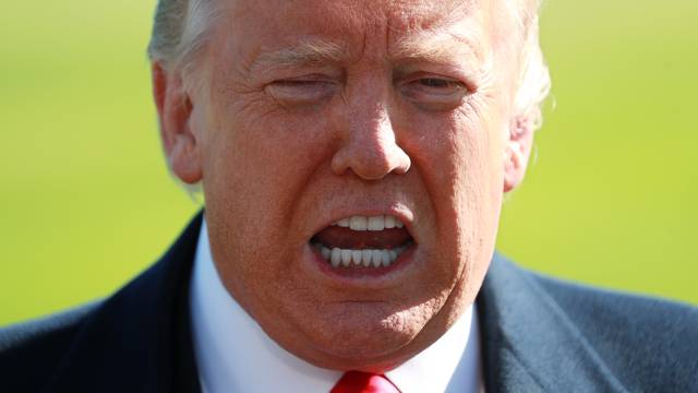 U.S. President Trump talks to reporters as he departs for Texas from the White House in Washington