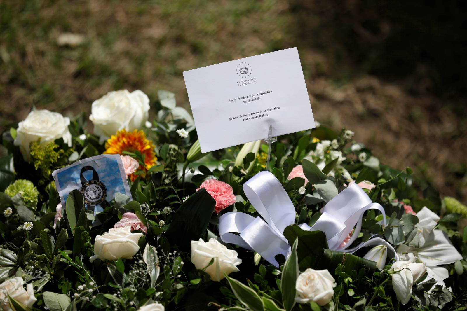 Flowers sent on behalf of the President of El Salvador, Nayib Bukele, and the first lady, Gabriela de Bukele, are seen at La Bermeja cemetery, where Oscar Alberto Martinez Ramirez and his daughter Valeria were buried in San Salvador