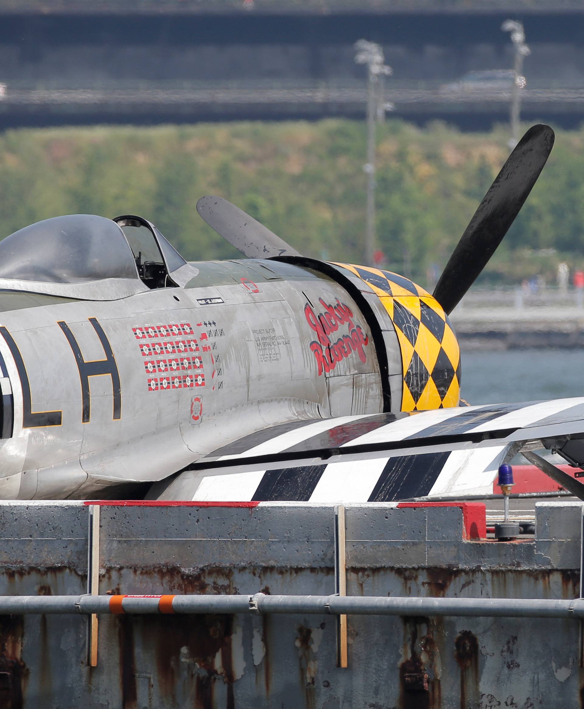 A worker photographs the wreckage of a vintage P-47 Thunderbolt airplane that crashed in the Hudson River in New York