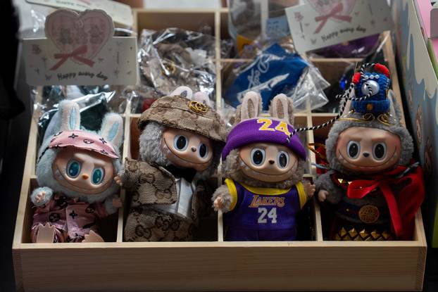 People sell counterfeit Labubu dolls on the sidewalk, in New York