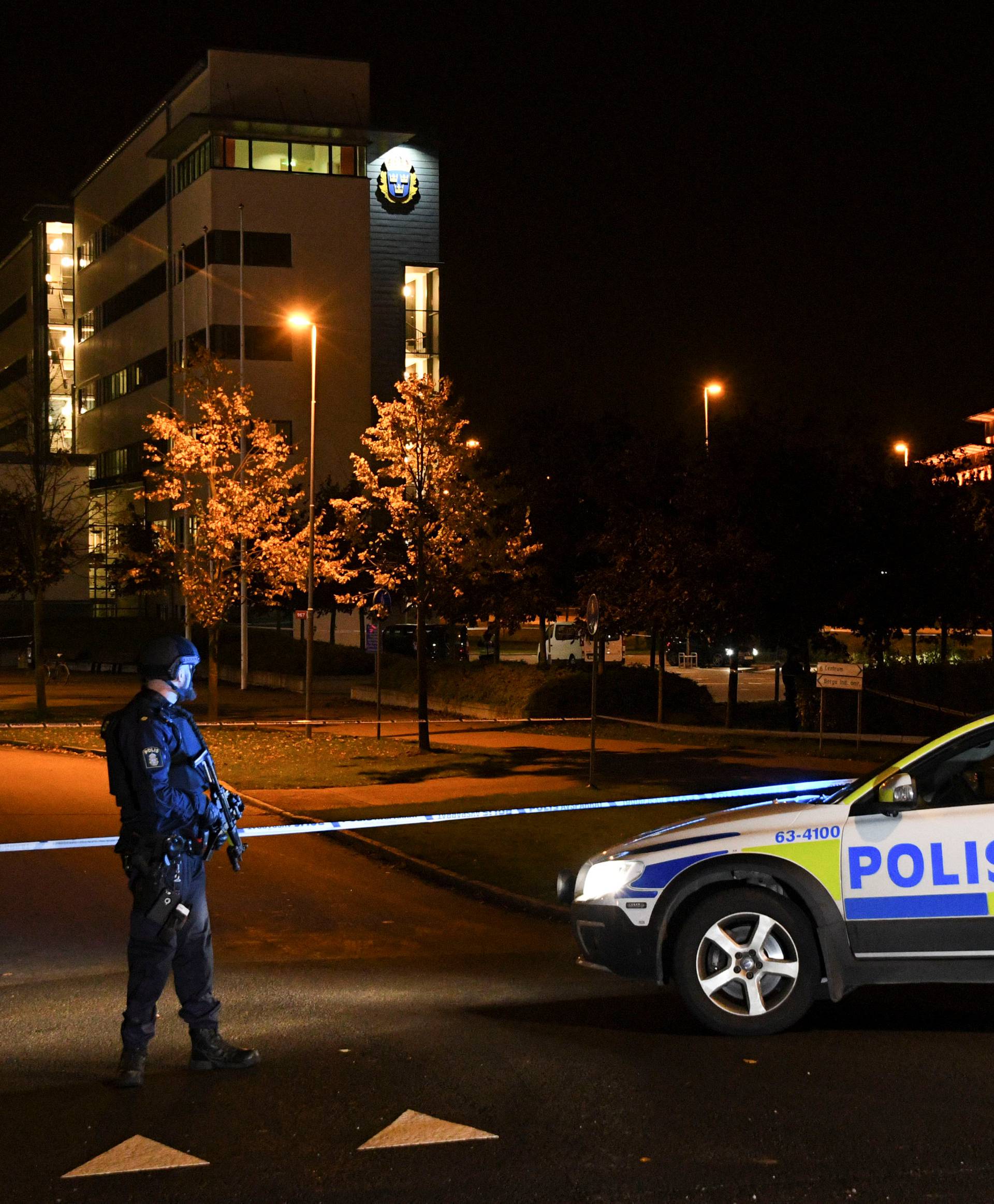 A police officer guards outside a cordoned area surrounding the police station in Helsingborg