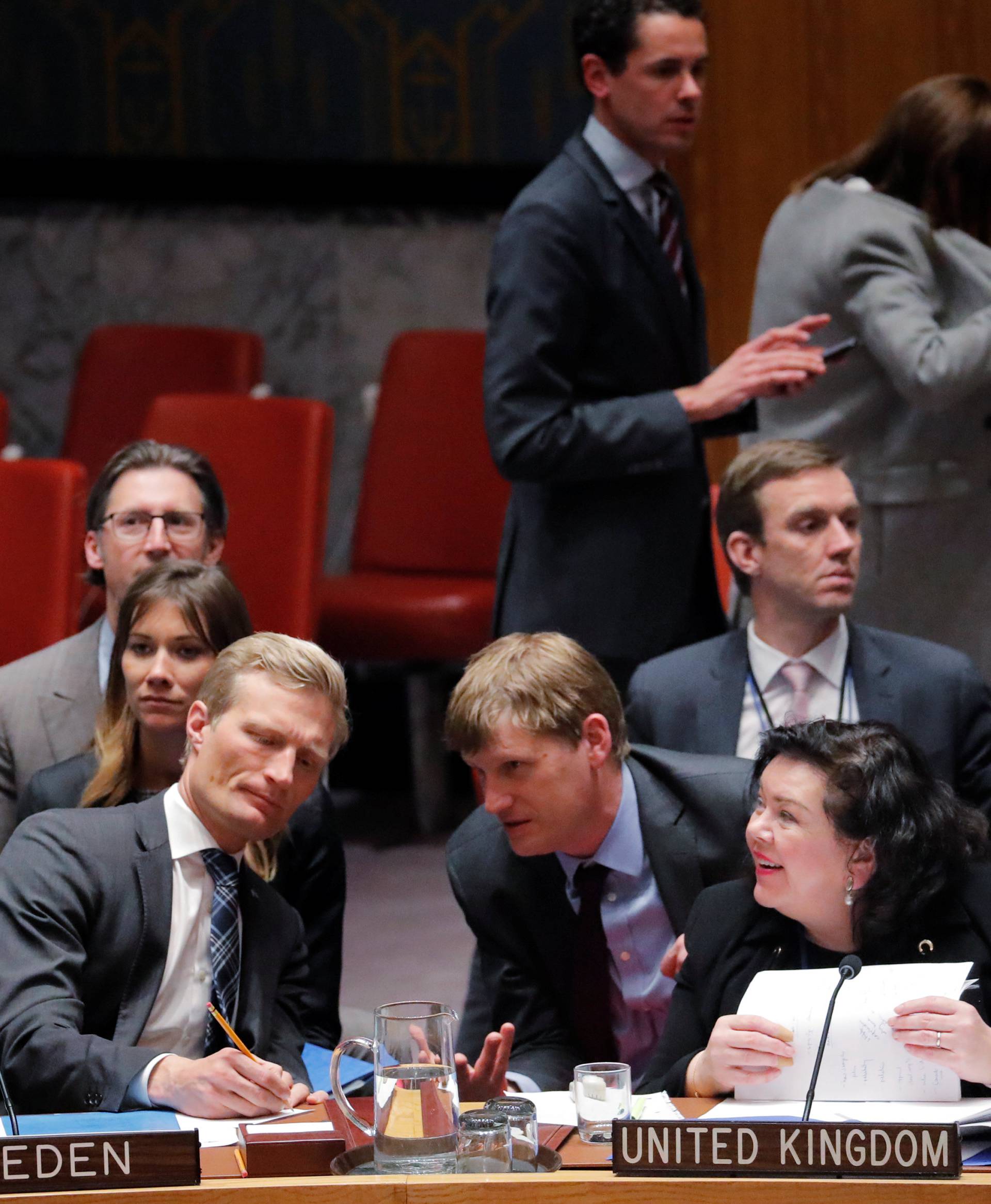 Russian Ambassador to the U.N., Nebenzya speaks with Britain's Ambassador to the U.N., Pierce, after a meeting convened to discuss an incident in Salisbury, during a meeting of the U.N. Security Council in New York