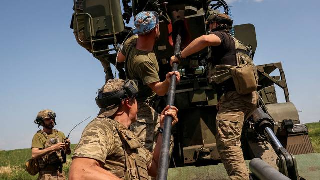 FILE PHOTO: Ukrainian servicemen prepare to fire a 2S22 Bohdana self-propelled howitzer towards Russian troops at a position near the city of Bakhmut