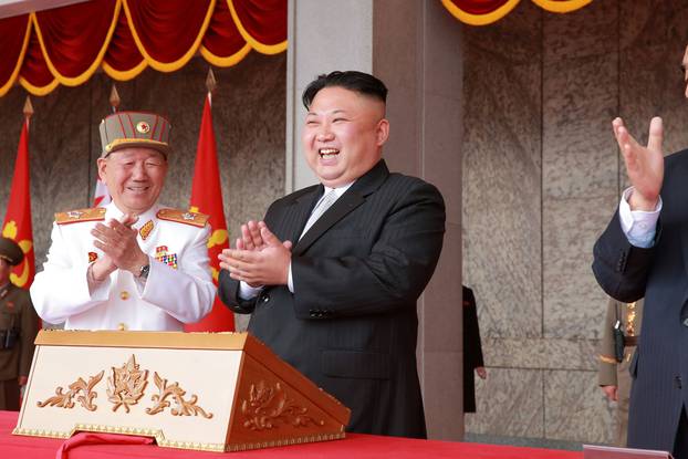 North Korean leader Kim Jong Un applauds during a military parade and a public procession of Pyongyang citizens celebrating the 105th birth anniversary of founder Kim Il Sung in this photo released by KCNA