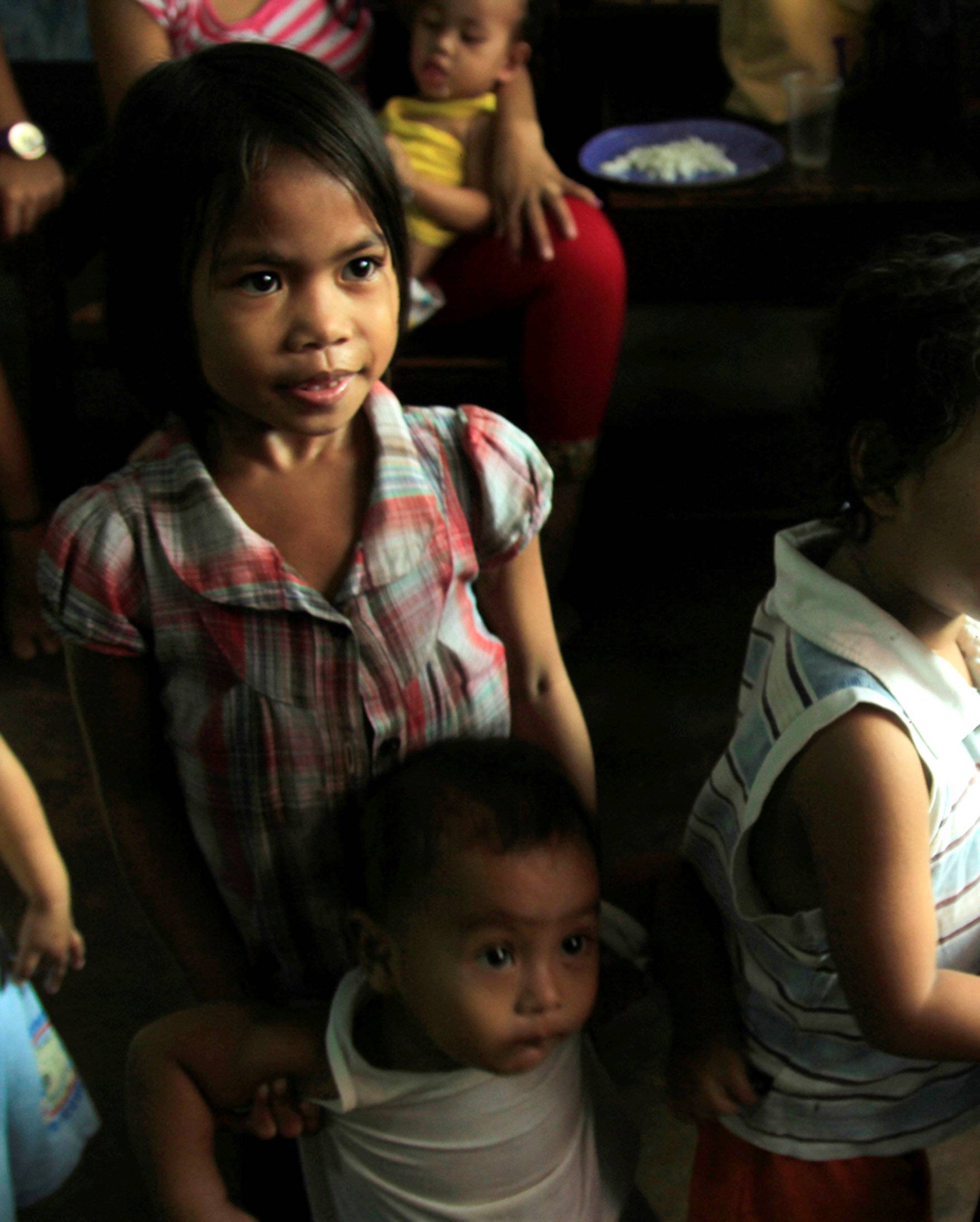 Children celebrate Christmas Day at the evacuation center before Typhoon Nock-ten is expected to strike Legazpi City, Albay province, central Philippines