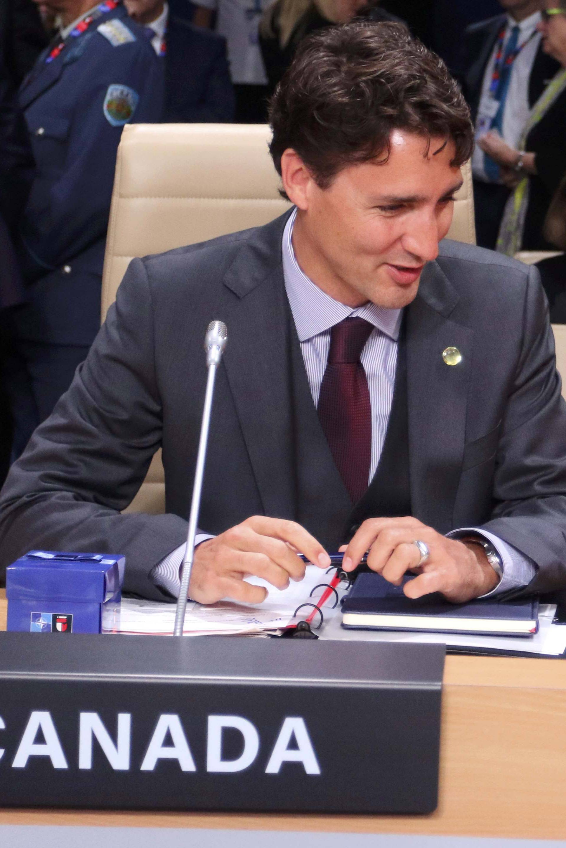 Canada's Prime Minister Trudeau talks to Croatia's President Grabar-Kitarovic during a session at the NATO Summit in Warsaw