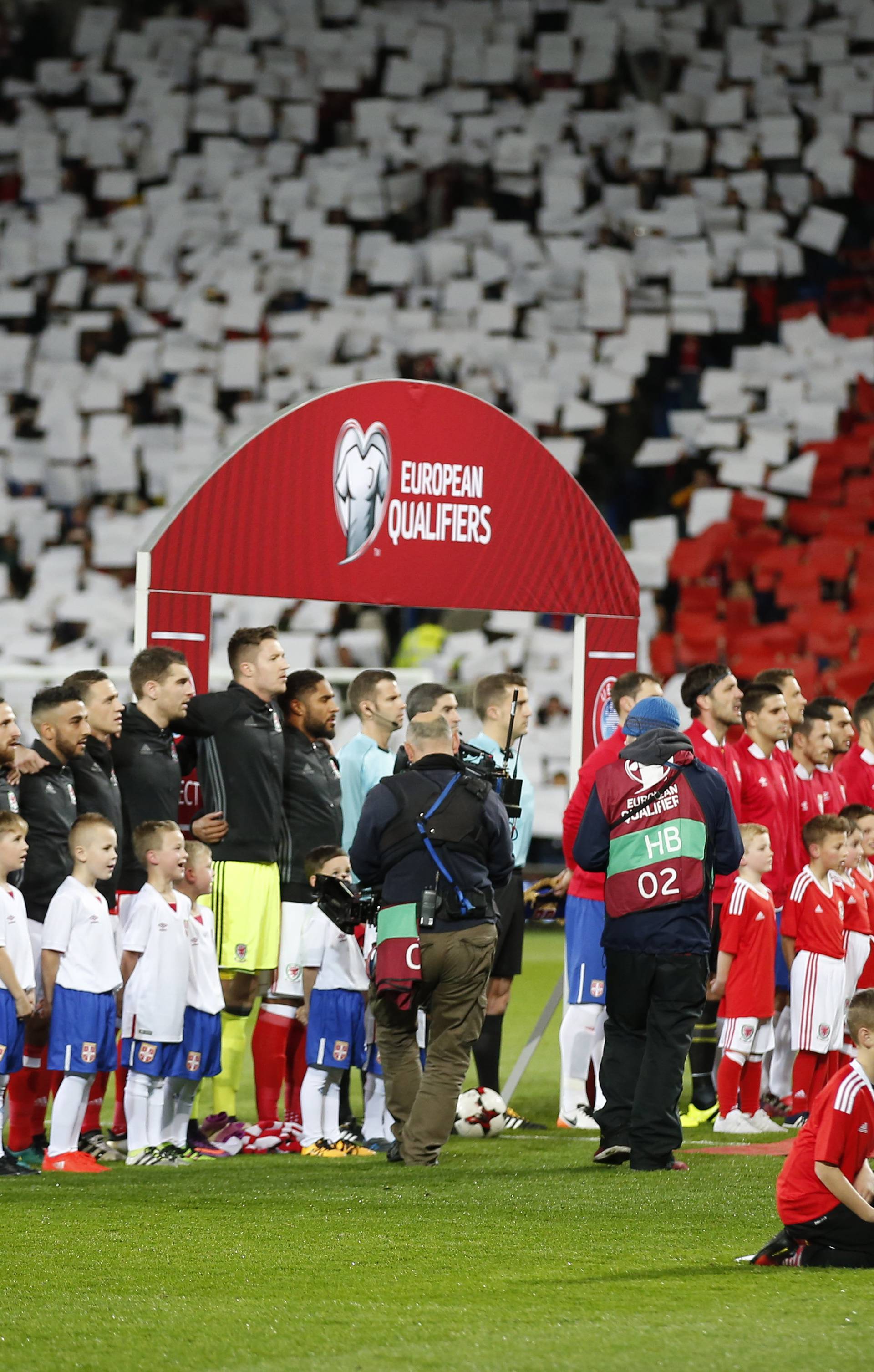 Fans display a poppy mosaic as the players line up before the match