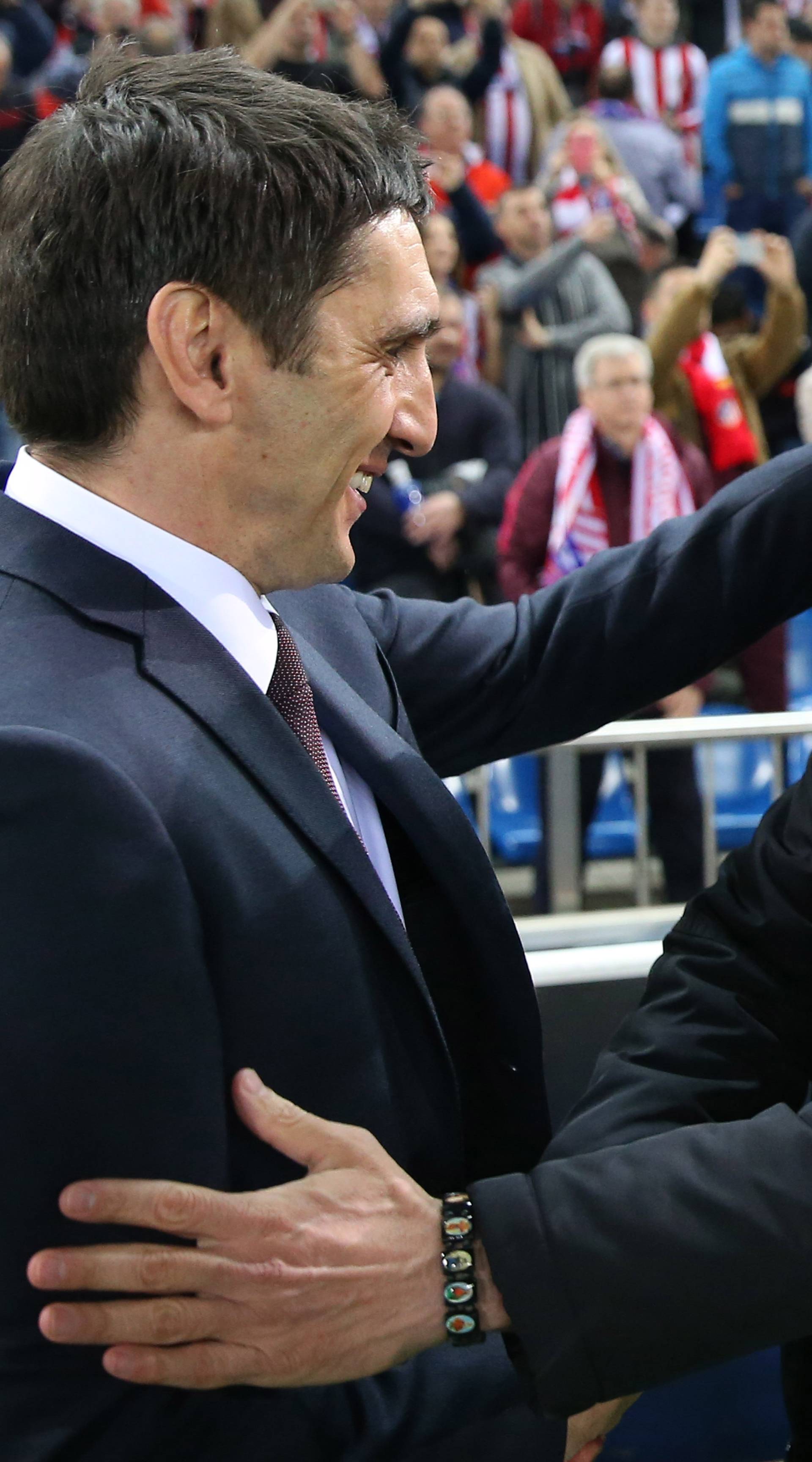 Atletico Madrid coach Diego Simeone greets Bayer Leverkusen coach Tayfun Korkut