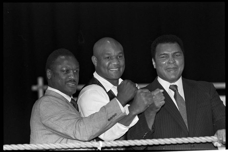 FILE PHOTO: FILE PHOTO: Boxers Joe Frazier, George Foreman and Muhammad Ali, raise fists at launch of film Champions Forever exploring their lives London.