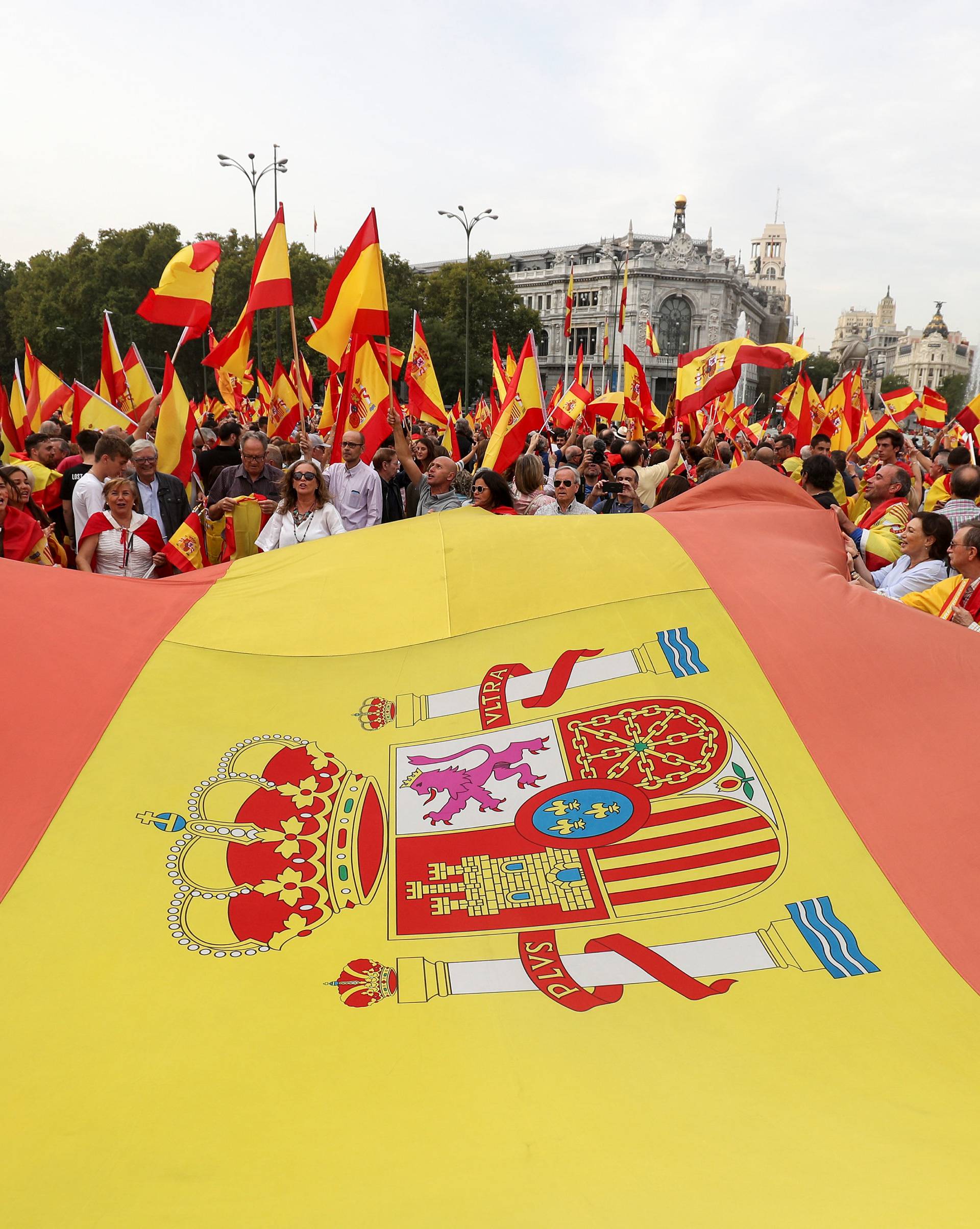 Demonstrators wave Spanish flags and shout in front of city hall during a demonstration in favor of a unified Spain a day before the banned October 1 independence referendum, in Madrid
