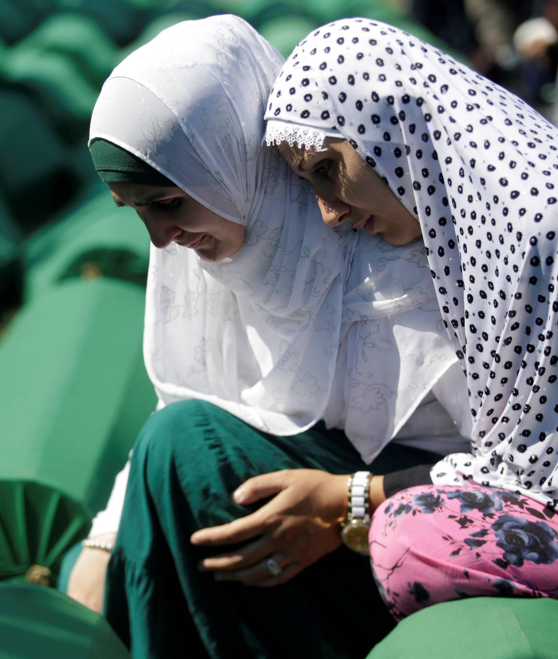 Muslim women cry near coffins of their relatives, who are newly identified victims of the 1995 Srebrenica massacre, which are lined up for a joint burial in Potocari near Srebrenica