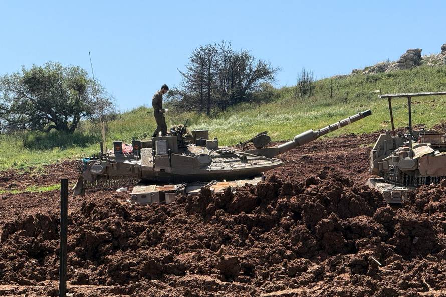 An Israeli soldier on tank, on the Israeli side of the Israel-Lebanon border, in northern Israel