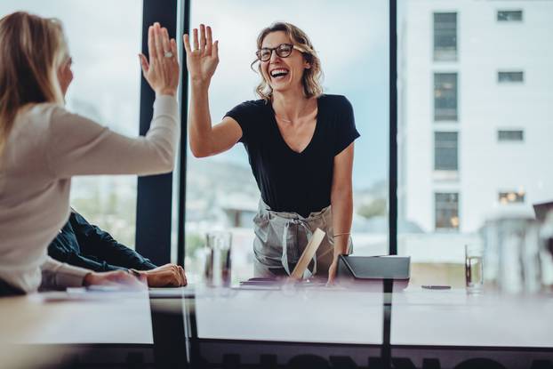 Businesswoman,Giving,High,Five,To,Colleague,In,Meeting.,Happy,Business
