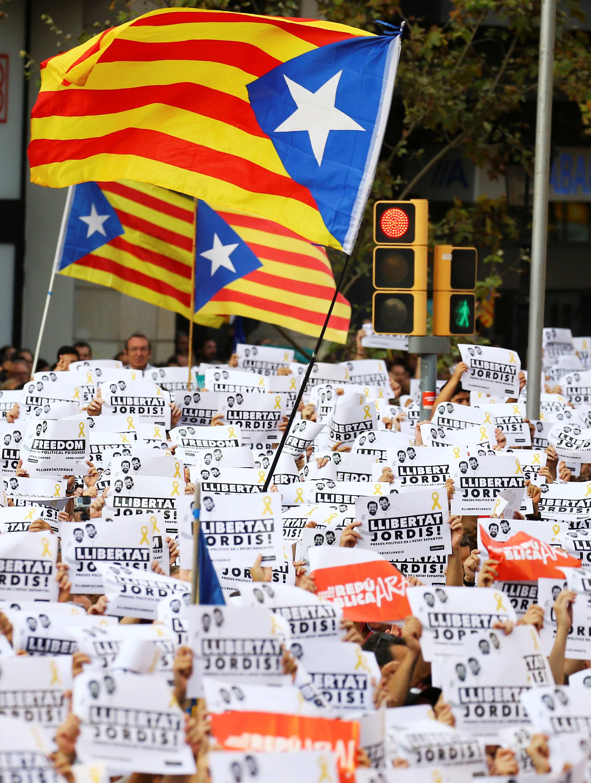 People wave placards which read "Freedom for the Jordis" in Catalan during a demonstration organised by Catalan pro-independence movements ANC (Catalan National Assembly) and Omnium Cutural, following the imprisonment of their two leaders in Barcelona