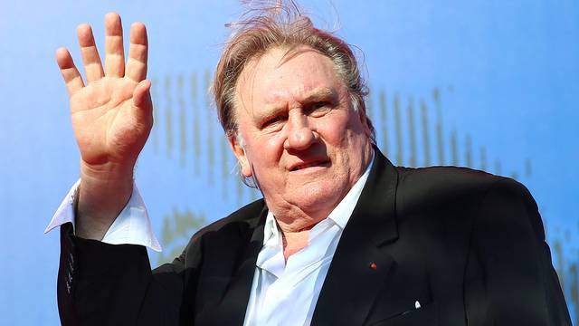 FILE PHOTO: Gerard Depardieu waves as he arrives during a red carpet event for the movie "Novecento- Atto Primo" at the 74th Venice Film Festival in Venice