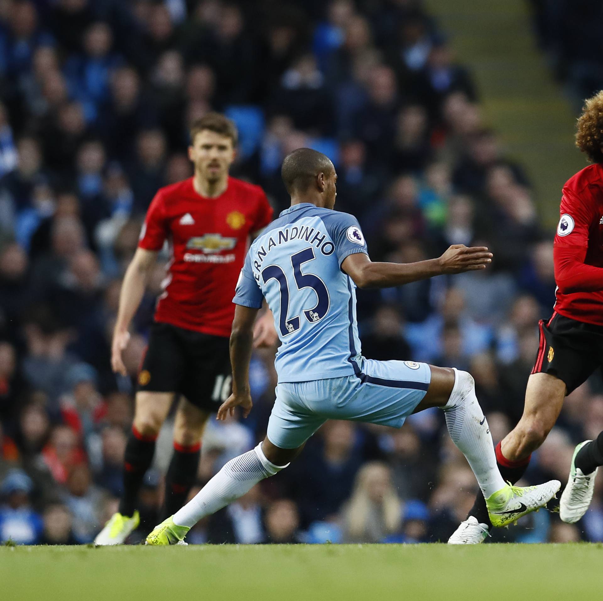 Manchester City's Fernandinho in action with Manchester United's Marouane Fellaini