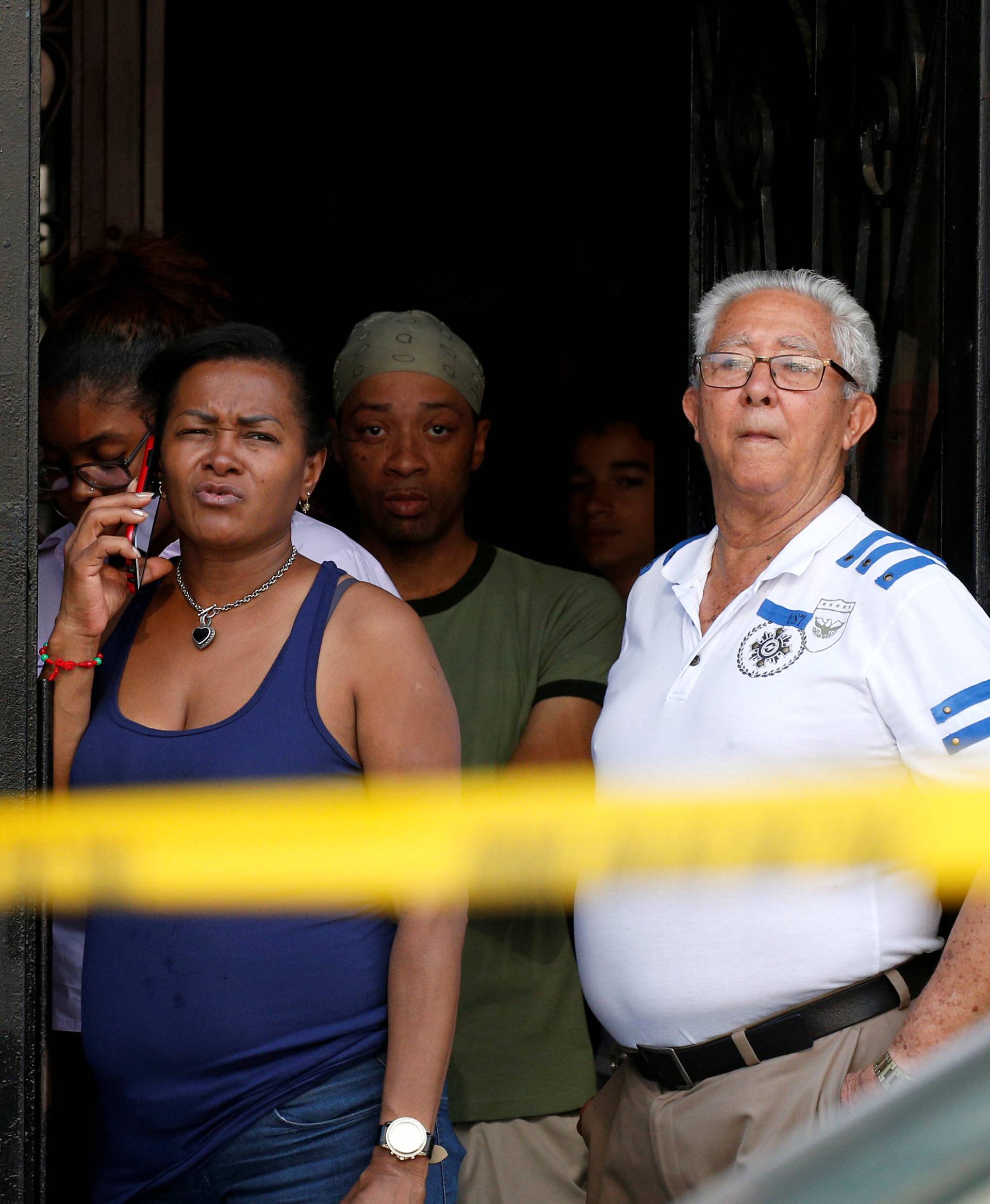 People watch near the scene at Bronx-Lebanon Hospital, after an incident in which a gunman fired shots inside the hospital in New York