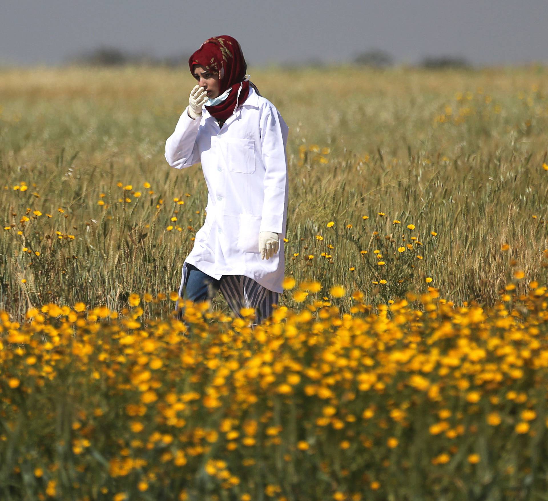 Female Palestinian medic Razan Al-Najar works at the scene of clashes at Israel-Gaza border, in the southern Gaza Strip