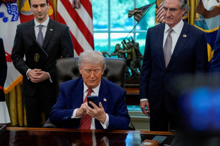 U.S. President Donald Trump signs executive orders at the White House in Washington