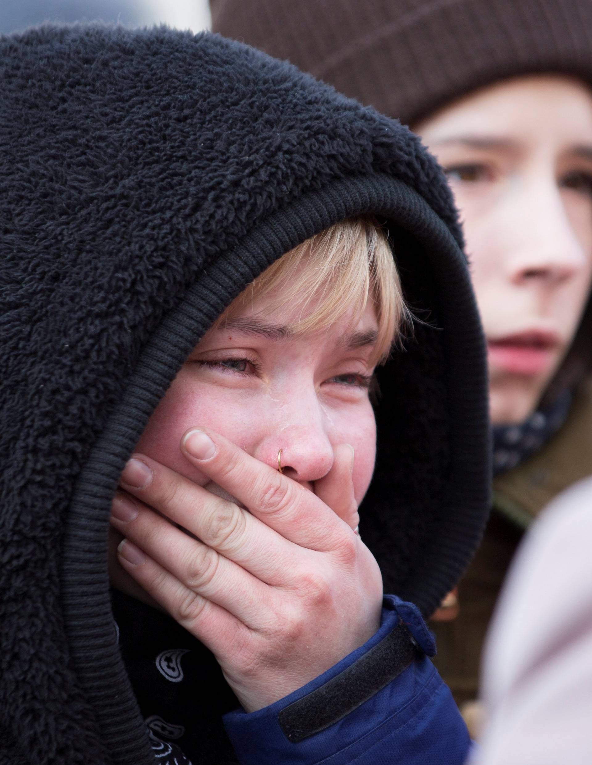 A youth mourns the victims of a shopping mall fire at a makeshift memorial in the Siberian city of Kemerovo