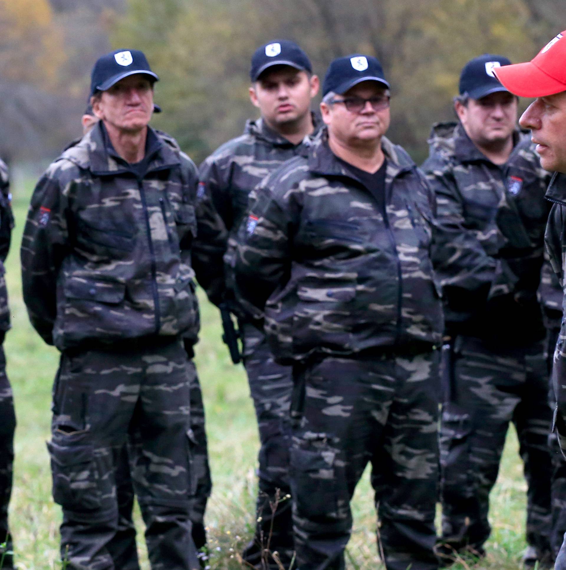 Andrej Sisko leader of Stajerska Varda (Stajerska Guard) is seen with uniformed volunteers while they hold exercises near the border with Croatia in Kostel