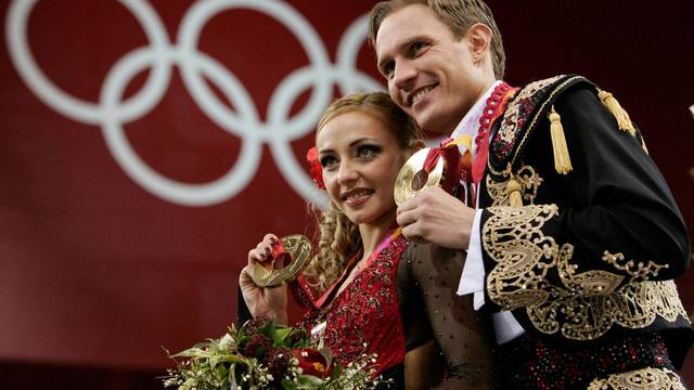 FILE PHOTO: Gold medal winners Tatiana Navka and Roman Kostomarov from Russia pose on the podium after the ice dancing competition at the 2006 Turing Winter Olympics