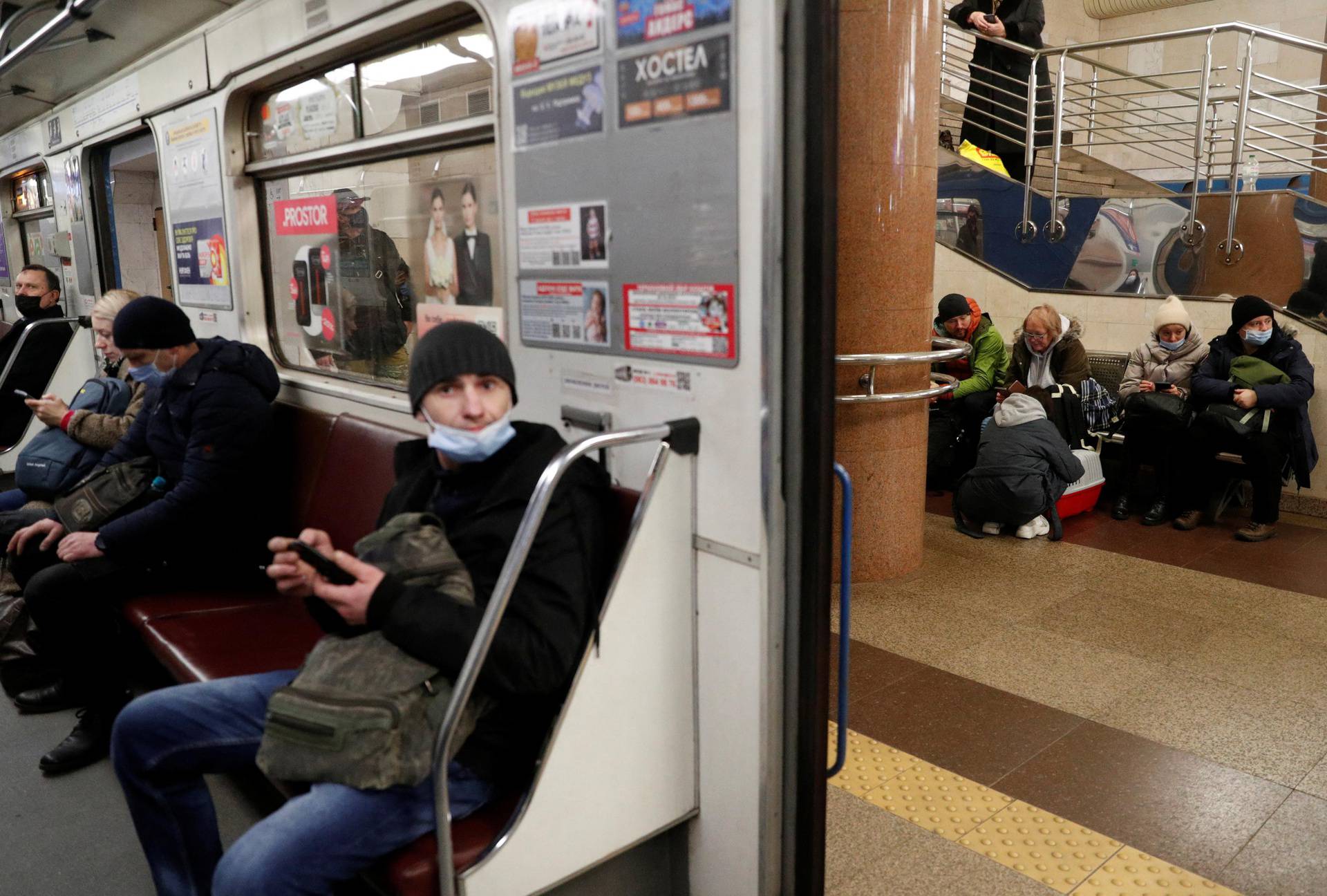 People taking shelter in a station are pictured from a subway car, after Russian President Vladimir Putin authorized a military operation in eastern Ukraine, in Kyiv