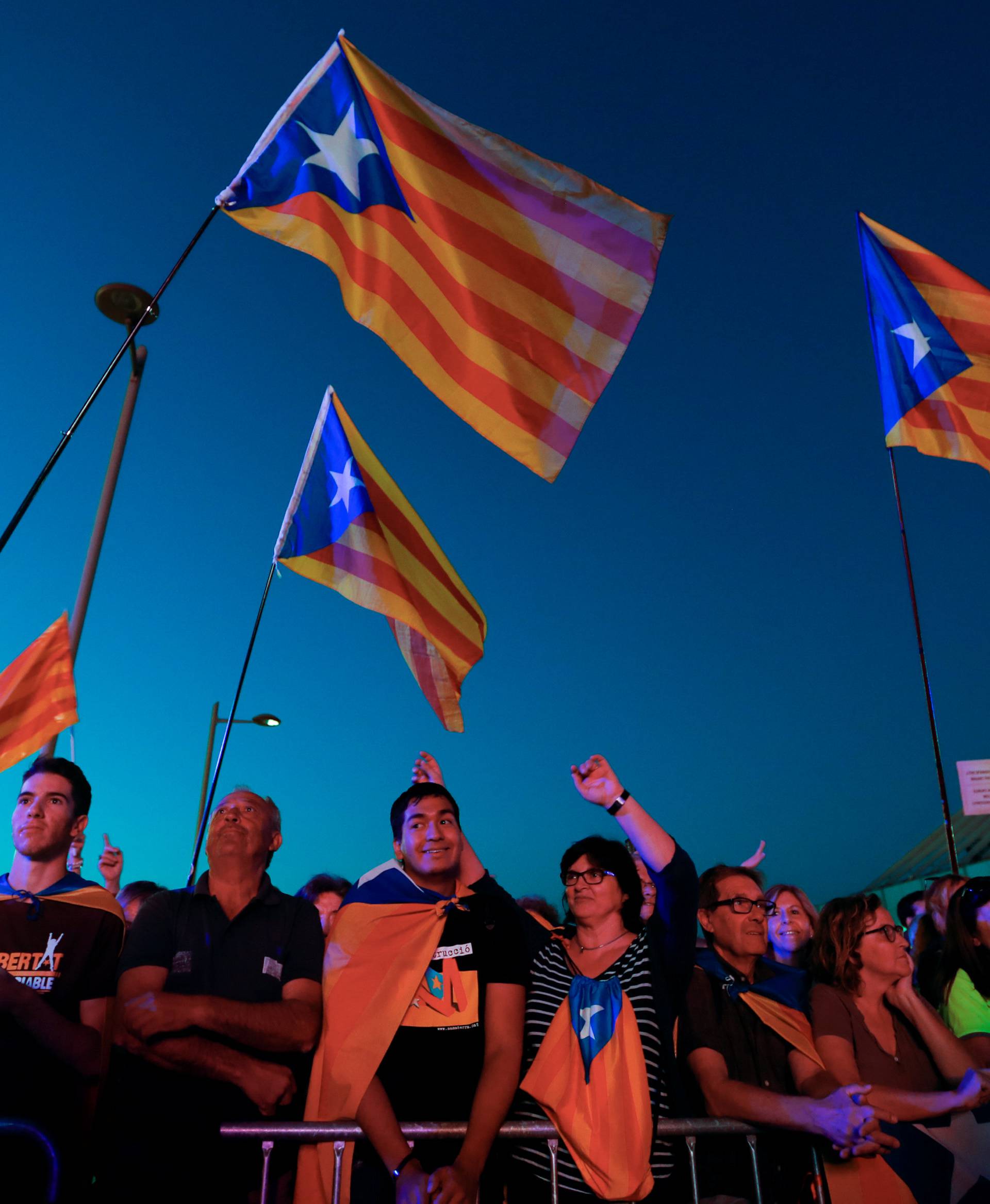 People react as they attend a closing rally in favour of the banned October 1 independence referendum in Barcelona