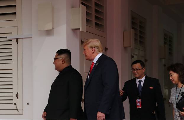 U.S. President Donald Trump walks with North Korean leader Kim Jong Un at the Capella Hotel on Sentosa island in Singapore