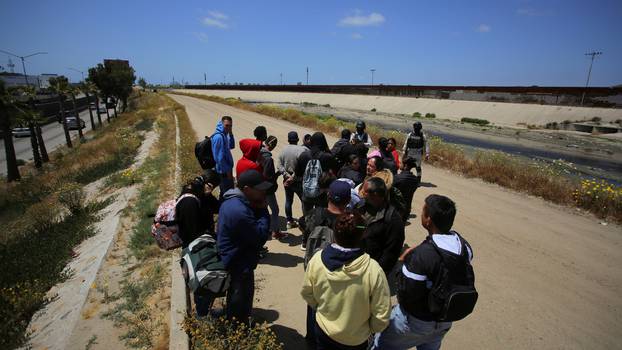 Migrants gather along the U.S. Mexico border before the lifting of Title 42, in Tijuana