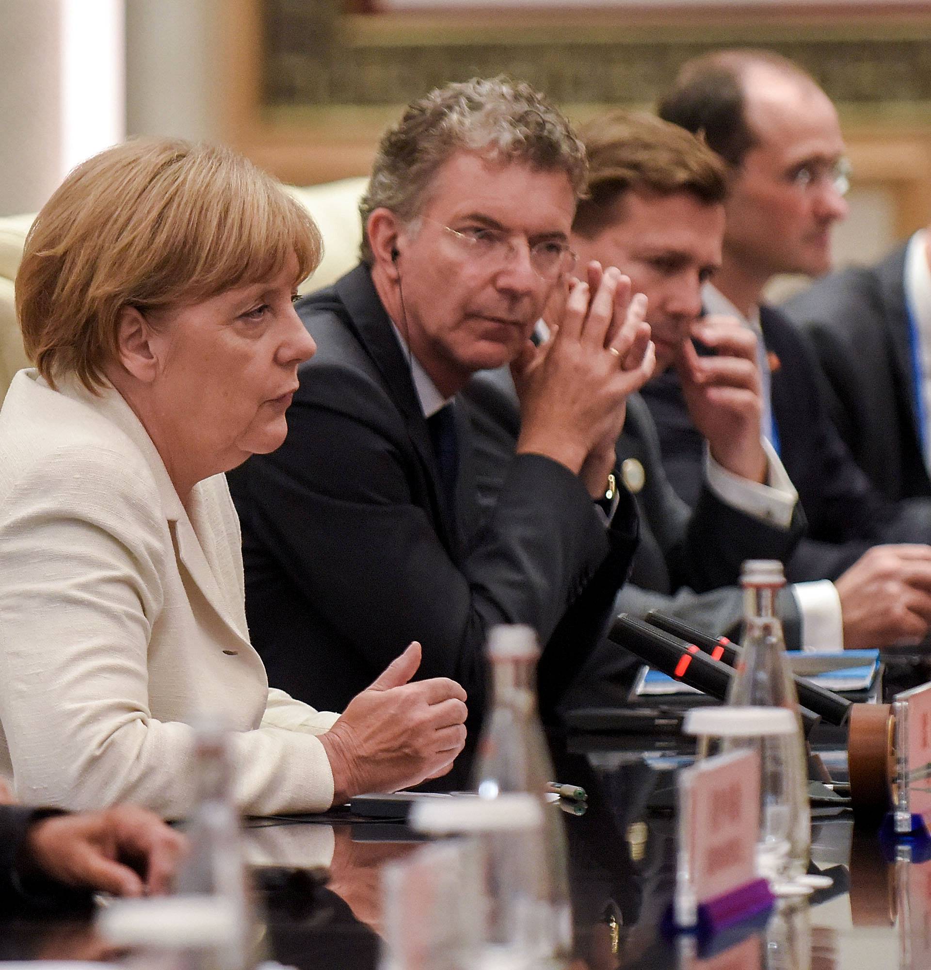 German Chancellor Angela Merkel waits after her meeting with Chinese President Xi Jinping at the West Lake State House on the sidelines of the G20 Summit, in Hangzhou