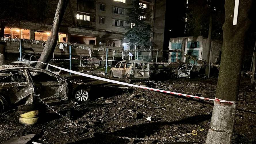 The wreckage of cars sit at the site of a Russian mass drone attack at a location given as Dnipro