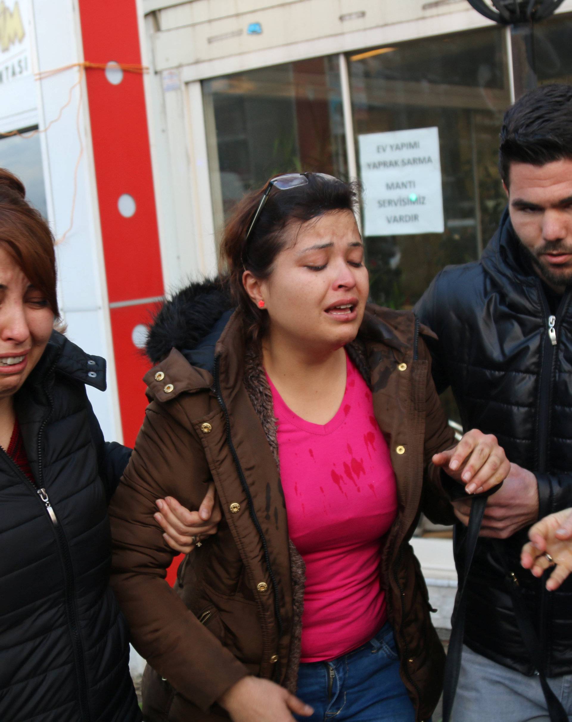 People react after an explosion outside a courthouse in Izmir