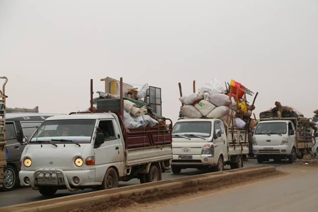 FILE PHOTO: Trucks carry belongings of people fleeing from Maarat al-Numan, in northern Idlib