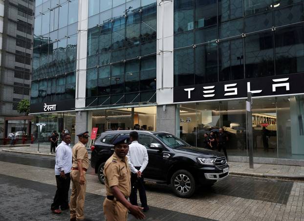 FILE PHOTO: Police direct traffic outside the Tesla showroom ahead of its opening in Mumbai