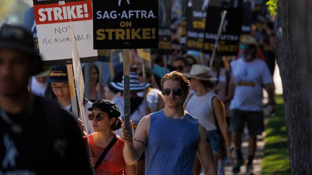 FILE PHOTO: Hollywood actors and writers on strike outside Disney studios in California