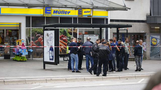 Security forces are seen after a knife attack in a supermarket in Hamburg