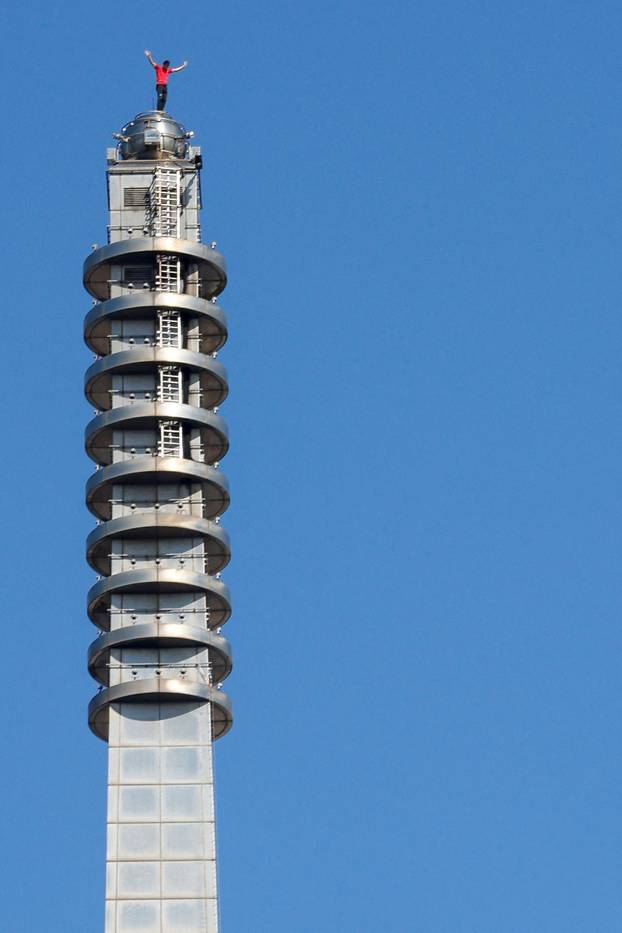 Climber Alex Honnold atop Taipei 101 after free soloing the skyscraper in Taipei