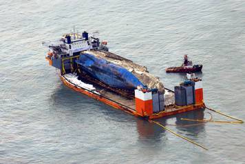 The sunken ferry Sewol sits on a semi-submersible ship during its salvage operations at the sea off Jindo