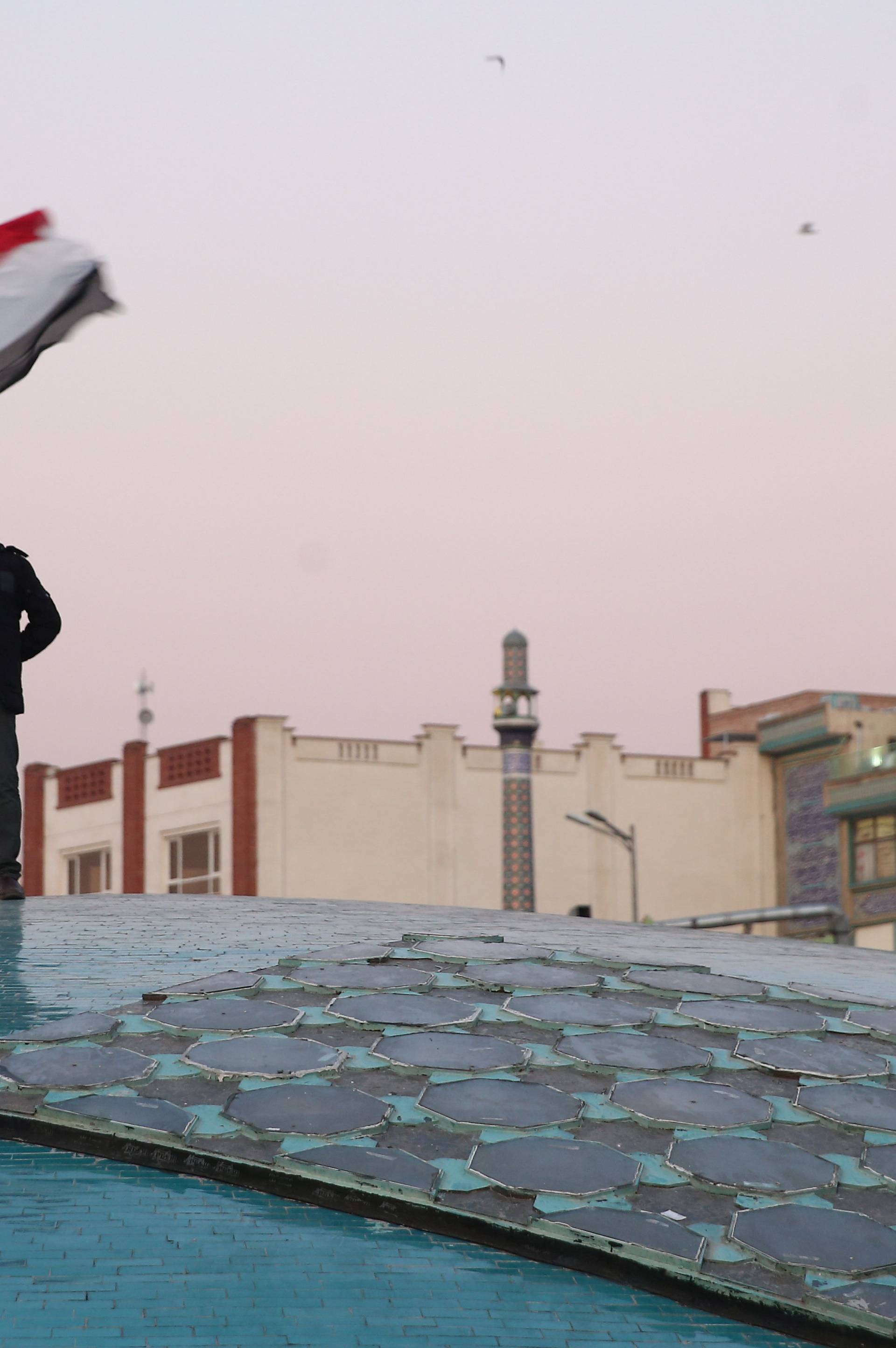 A man celebrates after Iran launched missiles at U.S.-led forces in Iraq, in Tehran