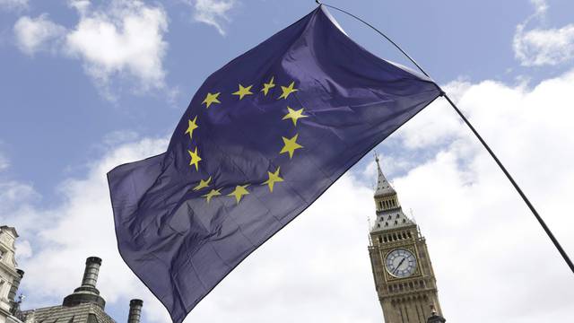 A European Union flag is held in front of the Big Ben clock tower in Parliament Square during a 'March for Europe' demonstration against Britain's decision to leave the European Union, central London