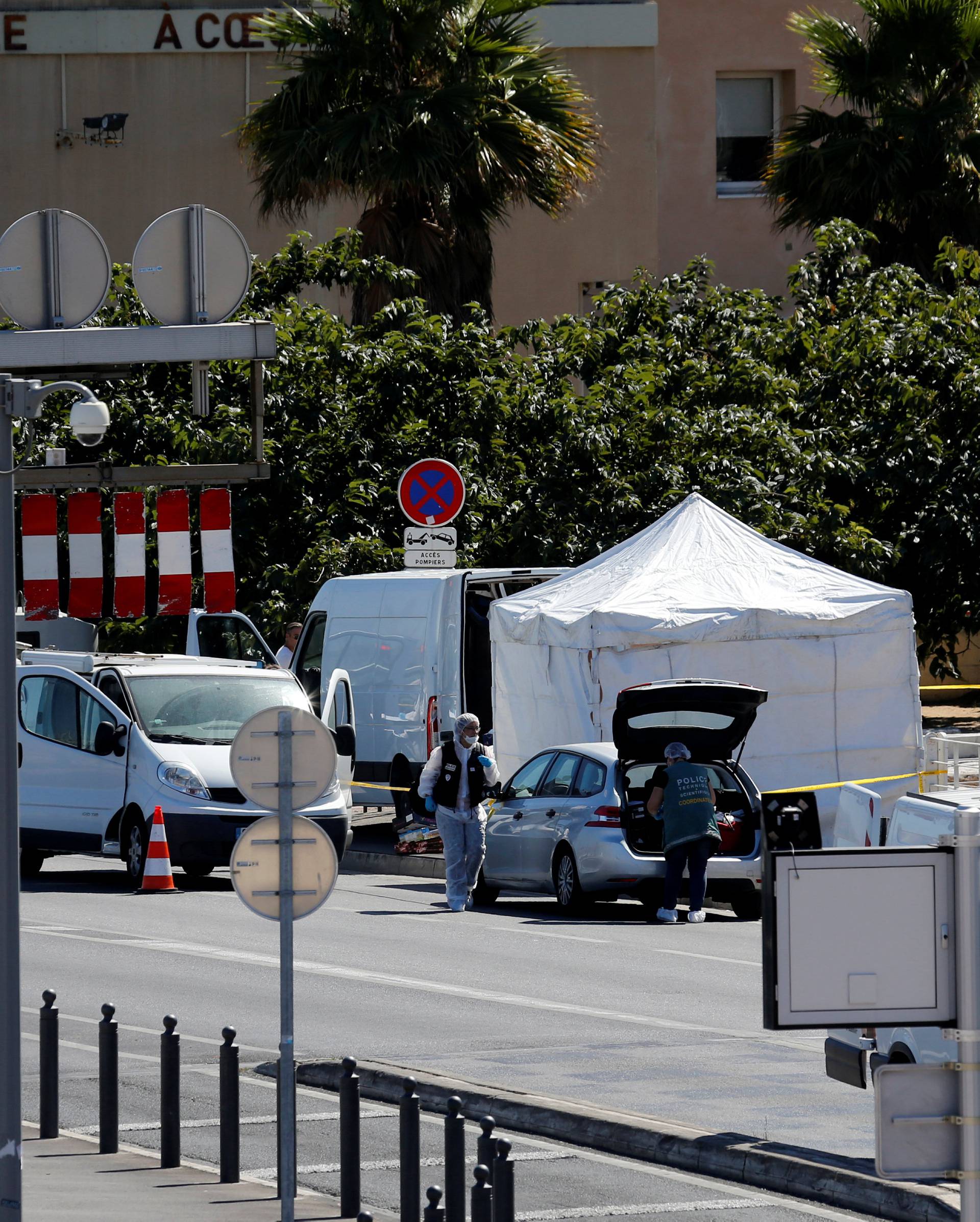 French police conduct their investigatation in the French port city of Marseille after one person was killed and another injured after a vehicle crashed into two bus shelters