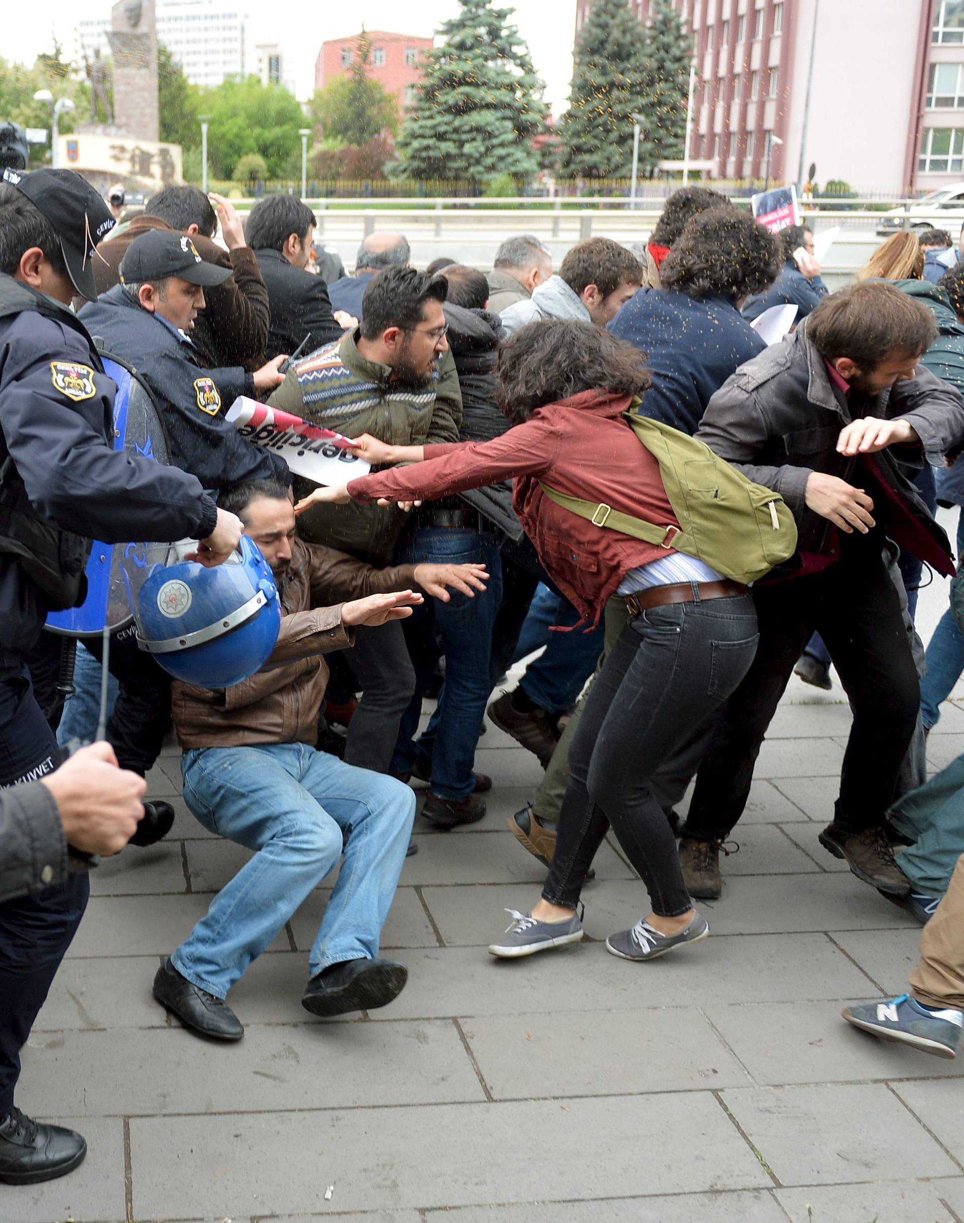 Riot police use tear gas to disperse demonstrators during a protest against parliament speaker Ismail Kahraman, outside the Turkish parliament in Ankara