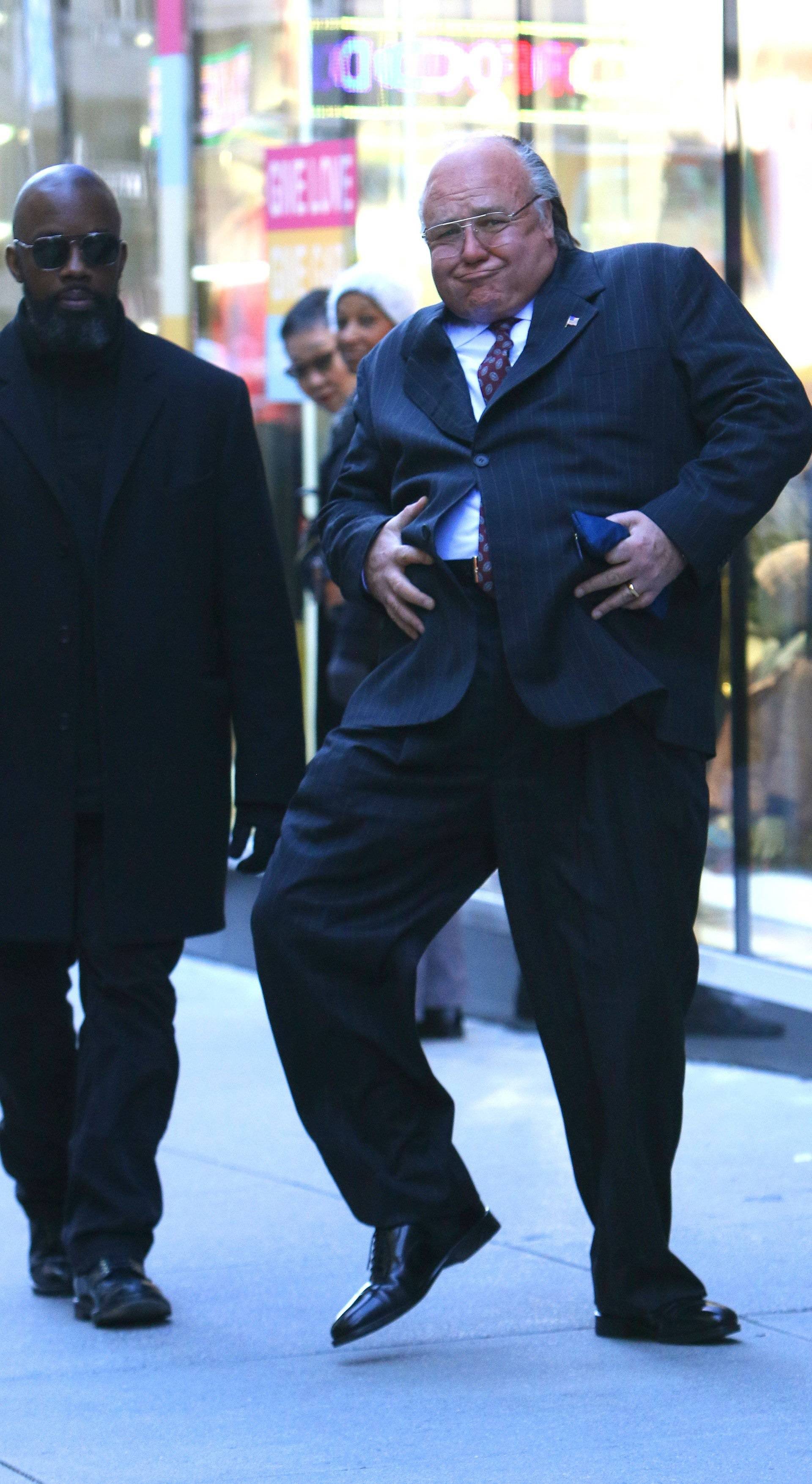 Russell Crowe gets playful with his prosthetic belly while filming "The Loudest Voice" in NYC