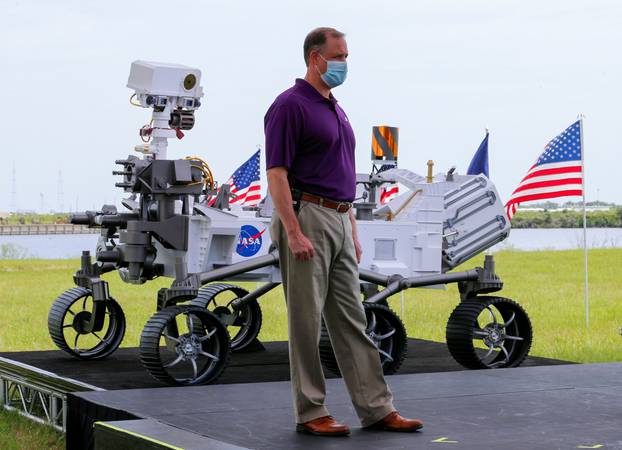NASA Administrator Jim Bridenstine stands next to a replica of the Mars 2020 Perseverance Rover during a press conference, at the Kennedy Space Center in Cape Canaveral