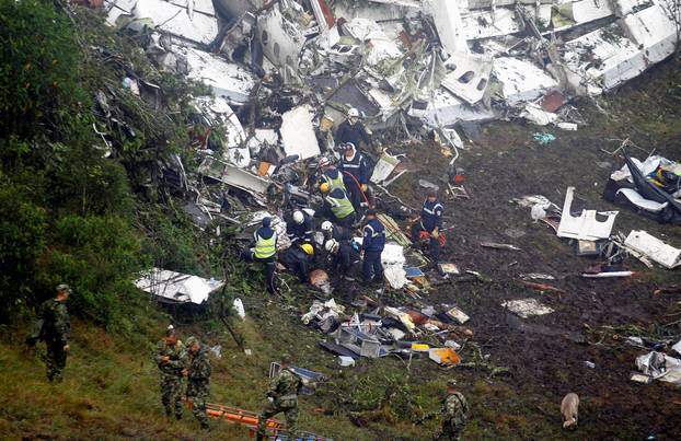 Rescue crew work in the wreckage from a plane that crashed into Colombian jungle with Brazilian soccer team Chapecoense, seen near Medellin