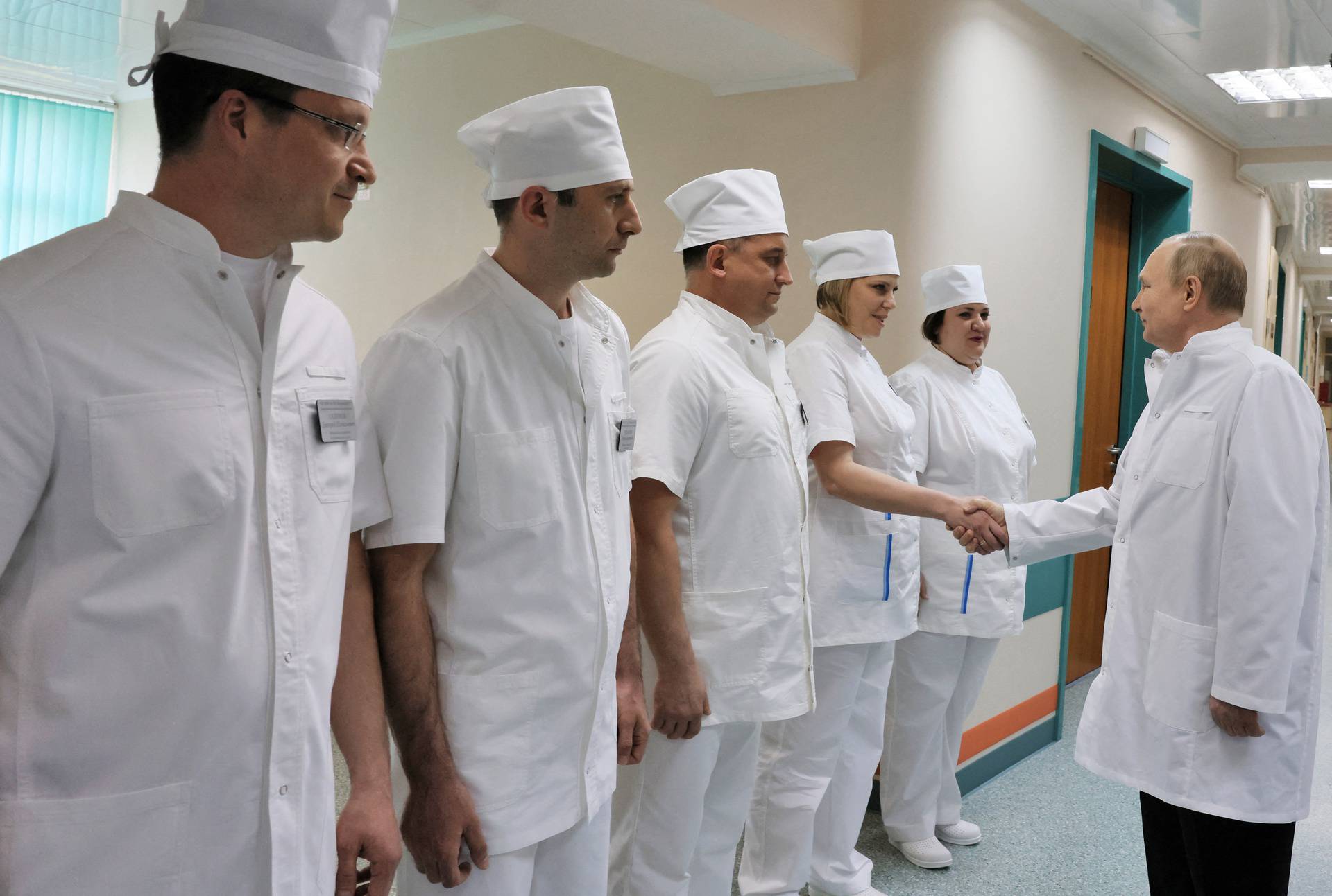 Russian President Vladimir Putin visits soldiers wounded during the conflict in Ukraine at a hospital in Moscow