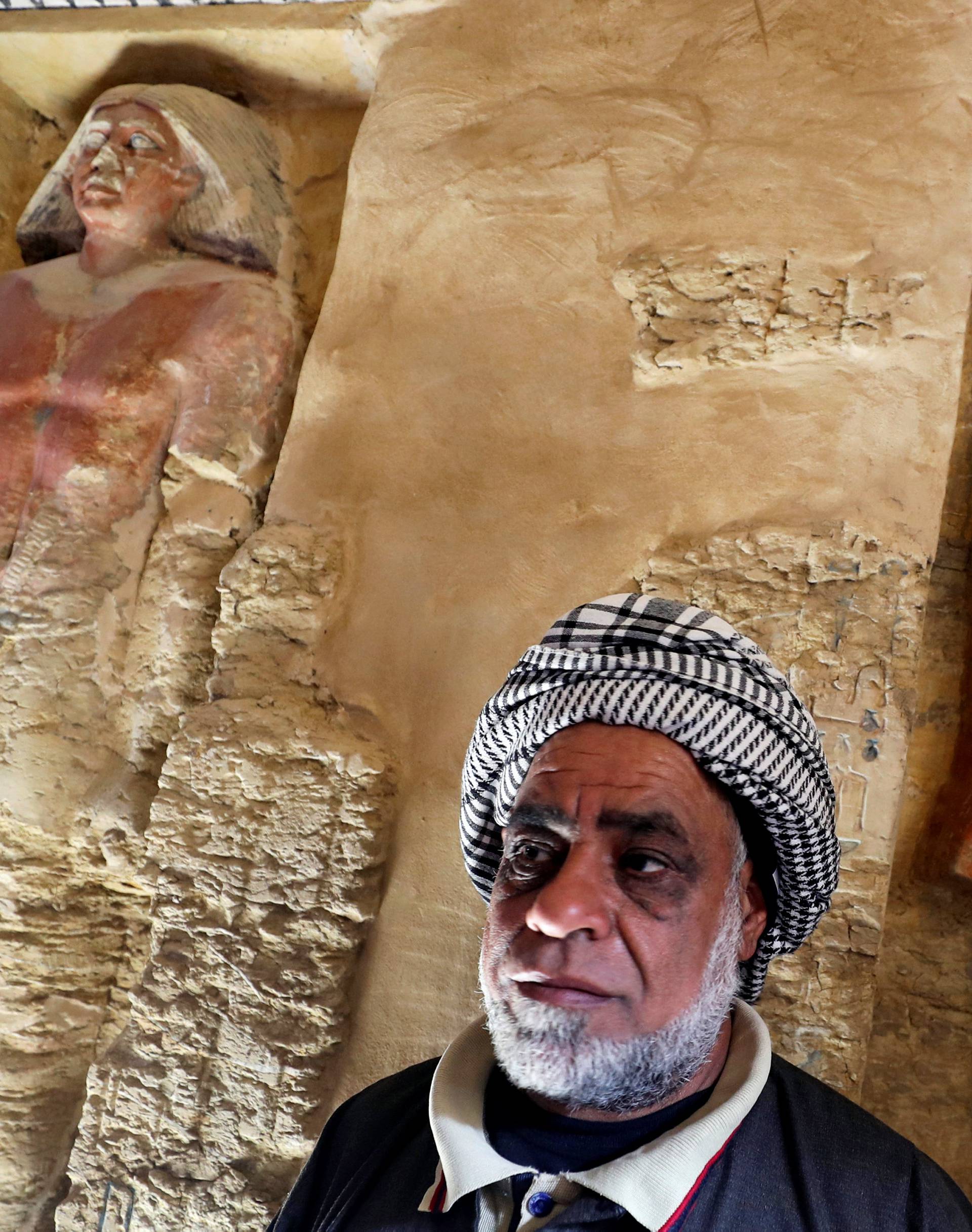 An Egyptian archaeological worker stands inside the newly-discovered tomb of 'Wahtye', which dates from the rule of King Neferirkare Kakai, at the Saqqara area near its necropolis, in Giza